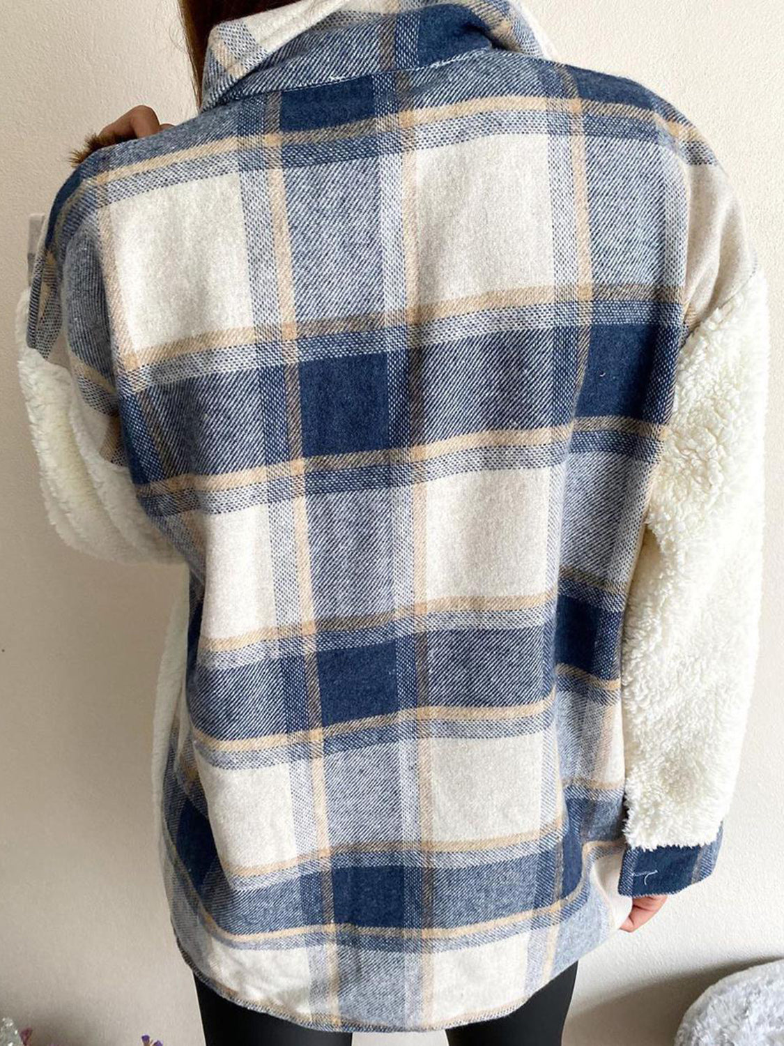 Plaid shacket with sherpa sleeves in blue and cream plaid.