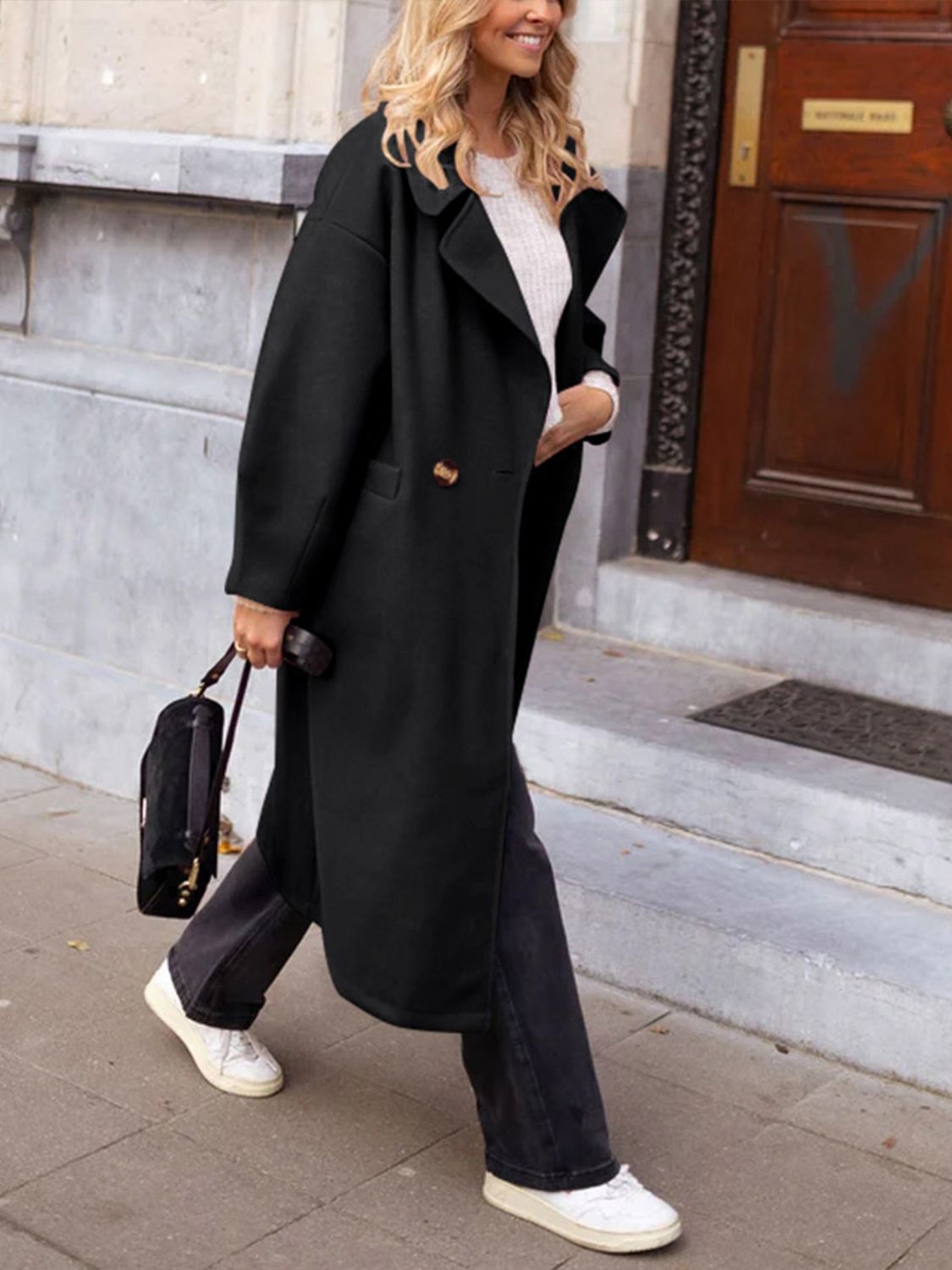 Black oversized wool-blend cocoon coat with double-breasted closure and wide lapels.