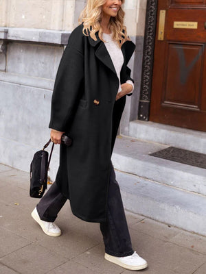 Black oversized wool-blend cocoon coat with double-breasted closure and wide lapels.