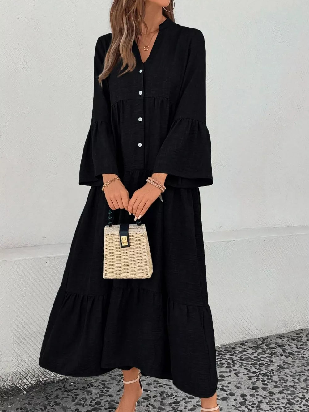 Black tiered ruffle hem v-neck midi dress with button front and bell sleeves.