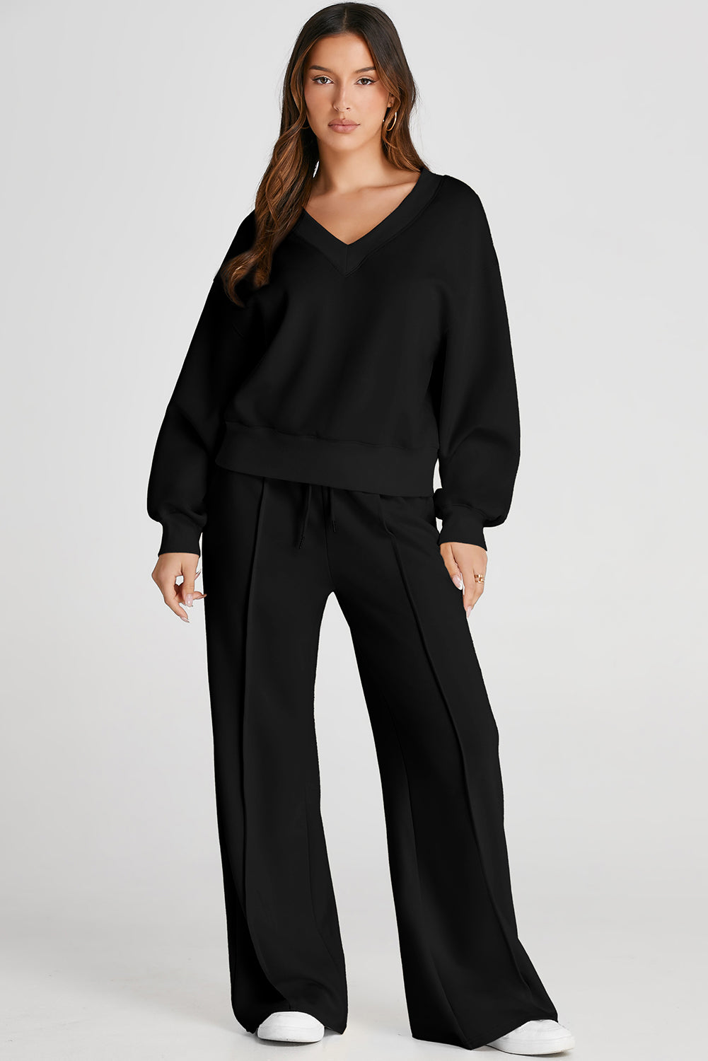 Black V-neck loungewear set with seam detail pants and relaxed fit top