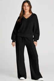 Black V-neck loungewear set with seam detail pants and relaxed fit top