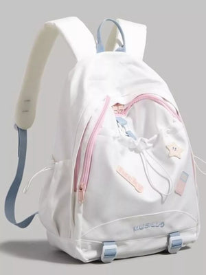 White drawstring backpack with pink zippers and pastel patches, blue straps.