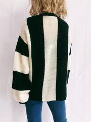 Black and cream vertical stripe waffle knit sweater with crew neck and long sleeves.