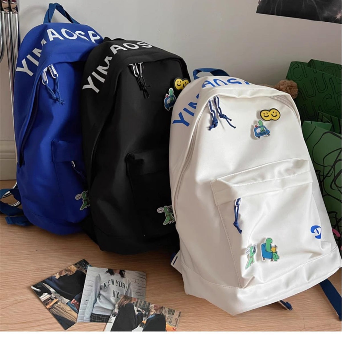 Nylon medium backpack in off-white with utility pocket and cute cartoon patches.