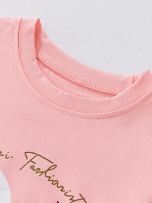 Blush pink toddler girls' t-shirt with gold script graphic detail.