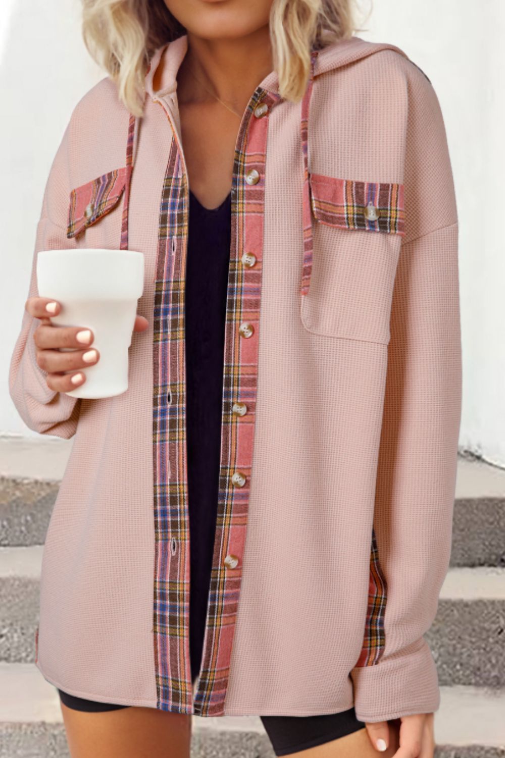 Blush pink waffle knit shacket with plaid trim on pockets and placket, featuring a hood.
