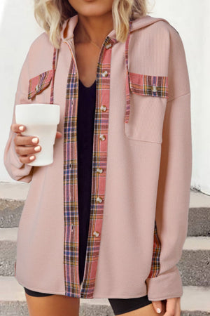 Blush pink waffle knit shacket with plaid trim on pockets and placket, featuring a hood.