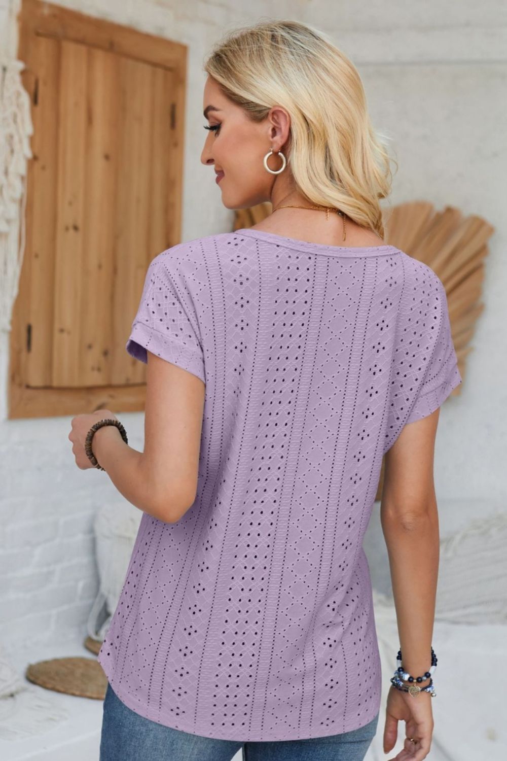 Lavender perforated eyelet cuffed tee with short sleeves and a scoop neckline.