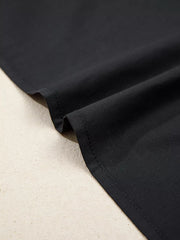 Black maternity overshirt detail showing fabric texture and stitching.