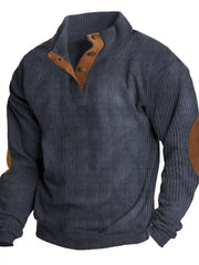 Blue corduroy long sleeve overshirt with button neck and elbow patches.