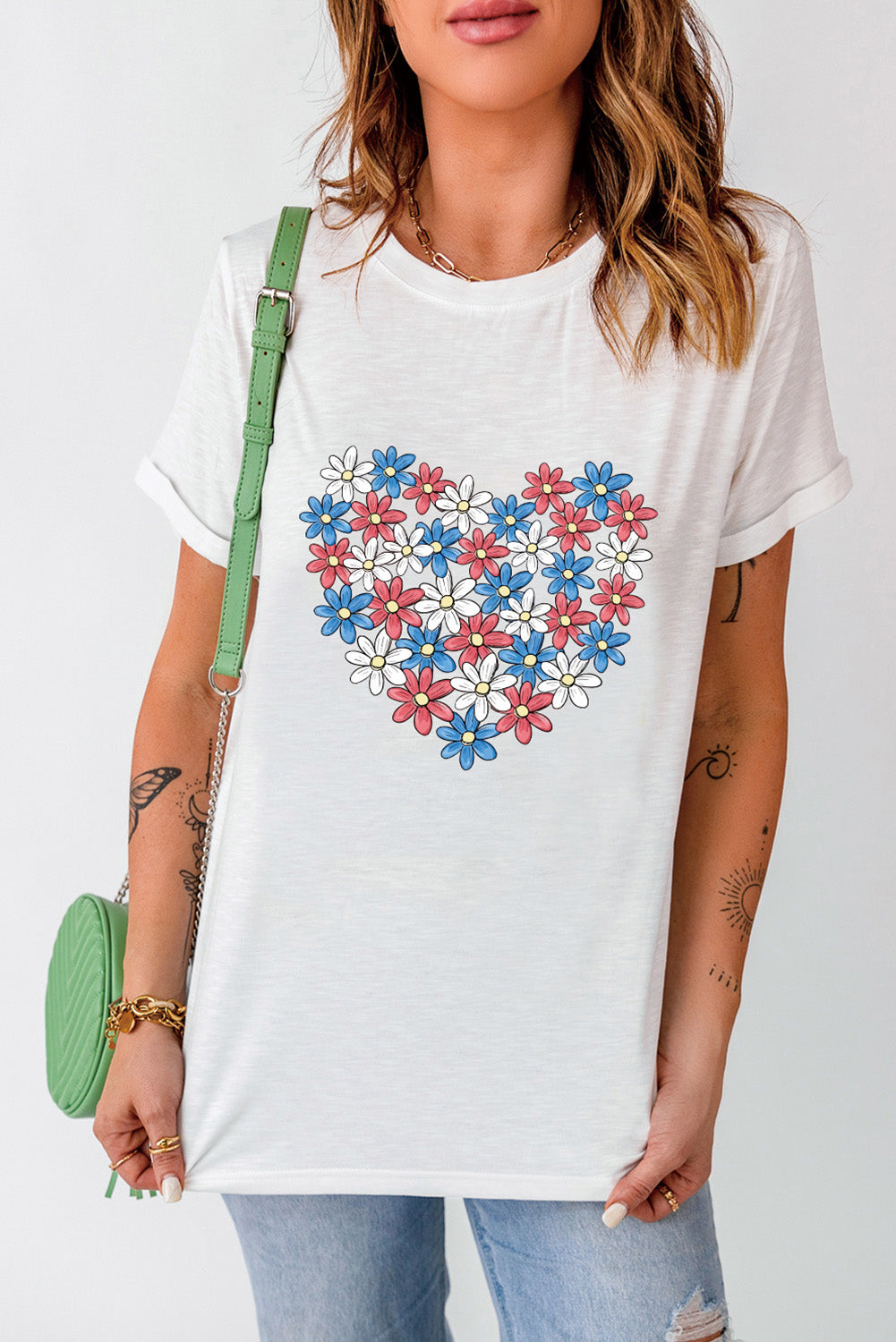 White t-shirt with red, white, and blue floral heart graphic.
