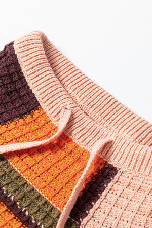 Waffle knit patchwork hoodie in orange, brown, green, and pink with drawstring detail.