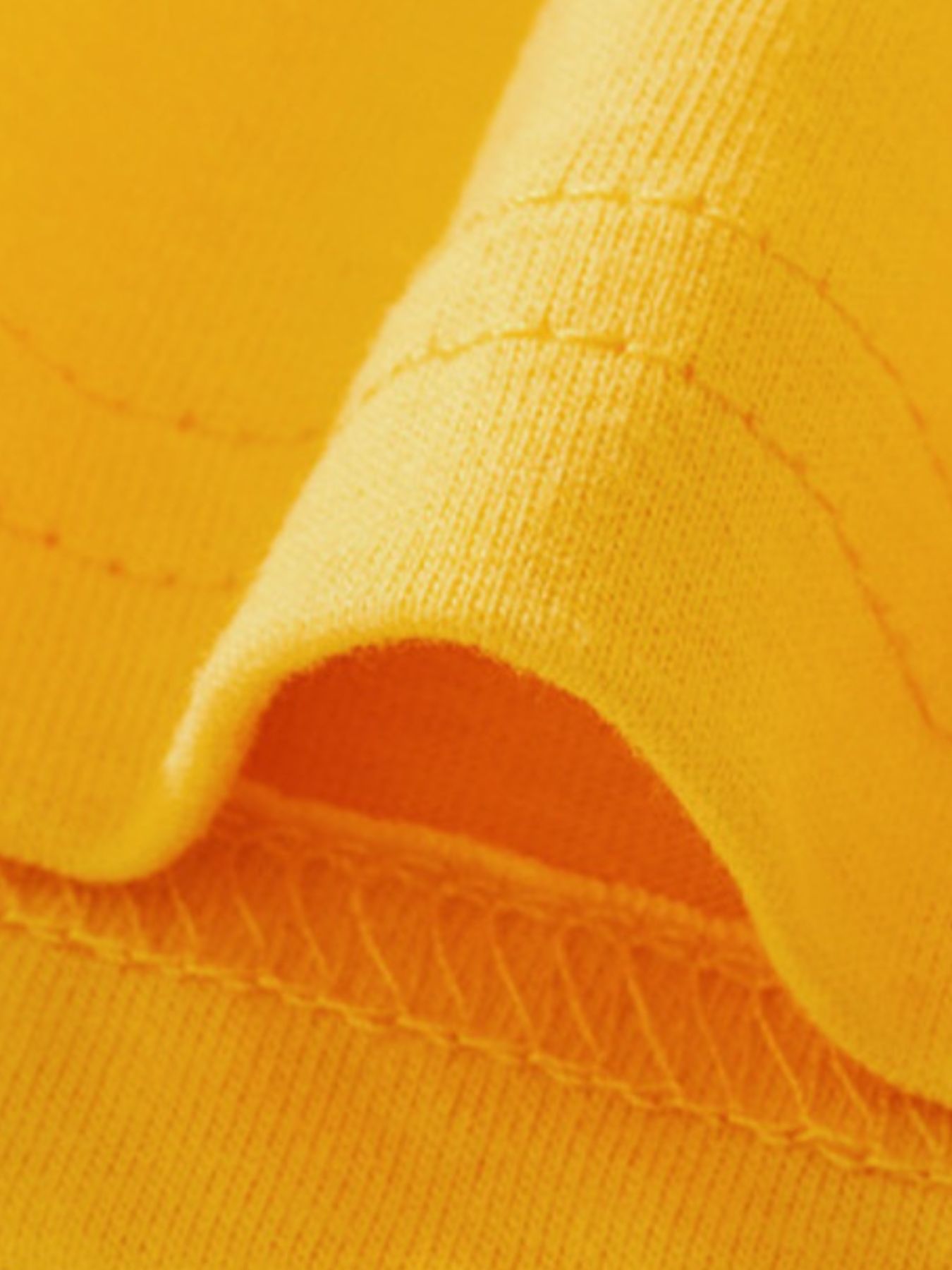 Yellow cotton toddler tee detail showing stitching and fabric texture.