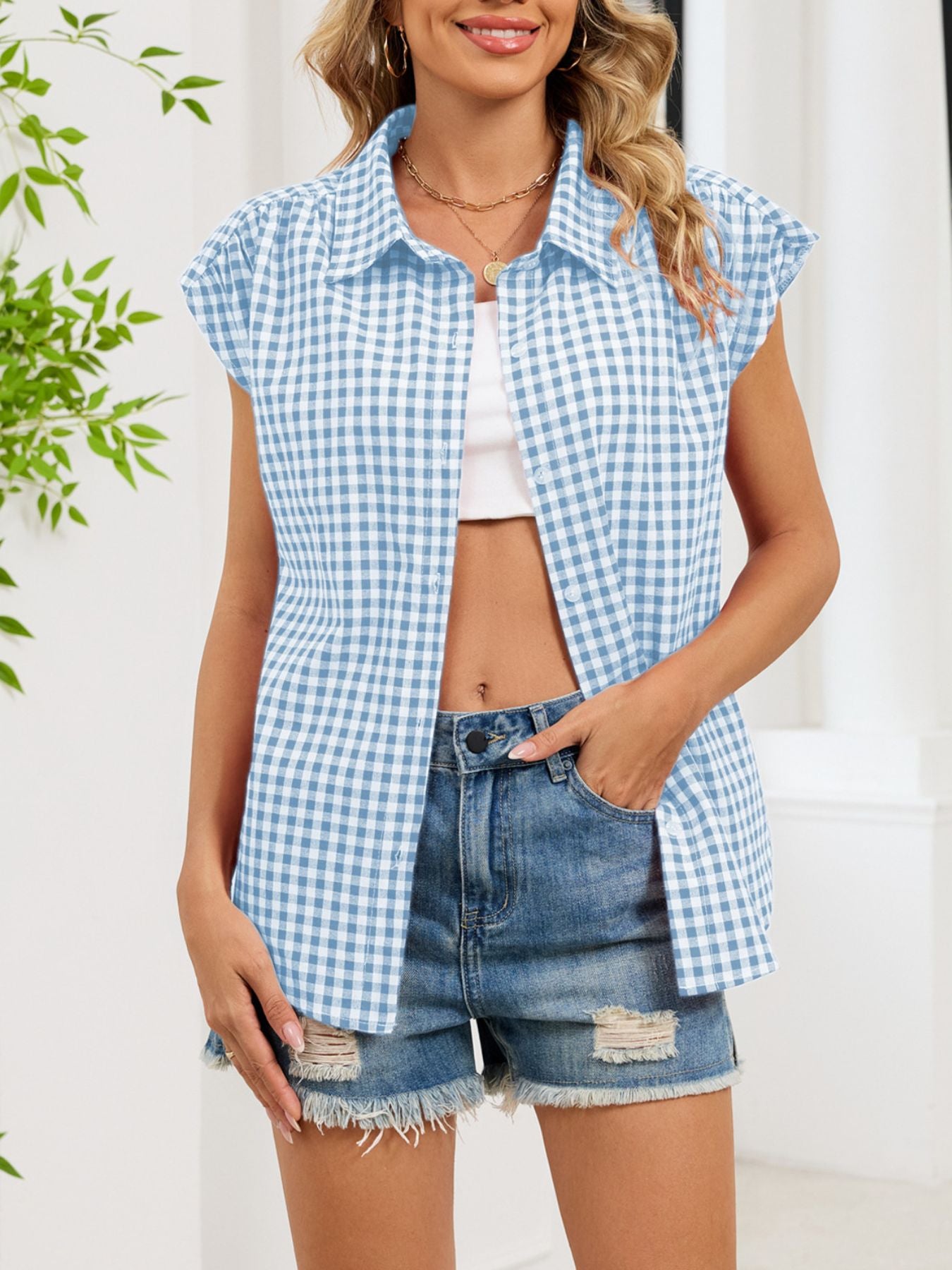 Sky blue gingham cotton shirt with cap sleeves and button-down front.