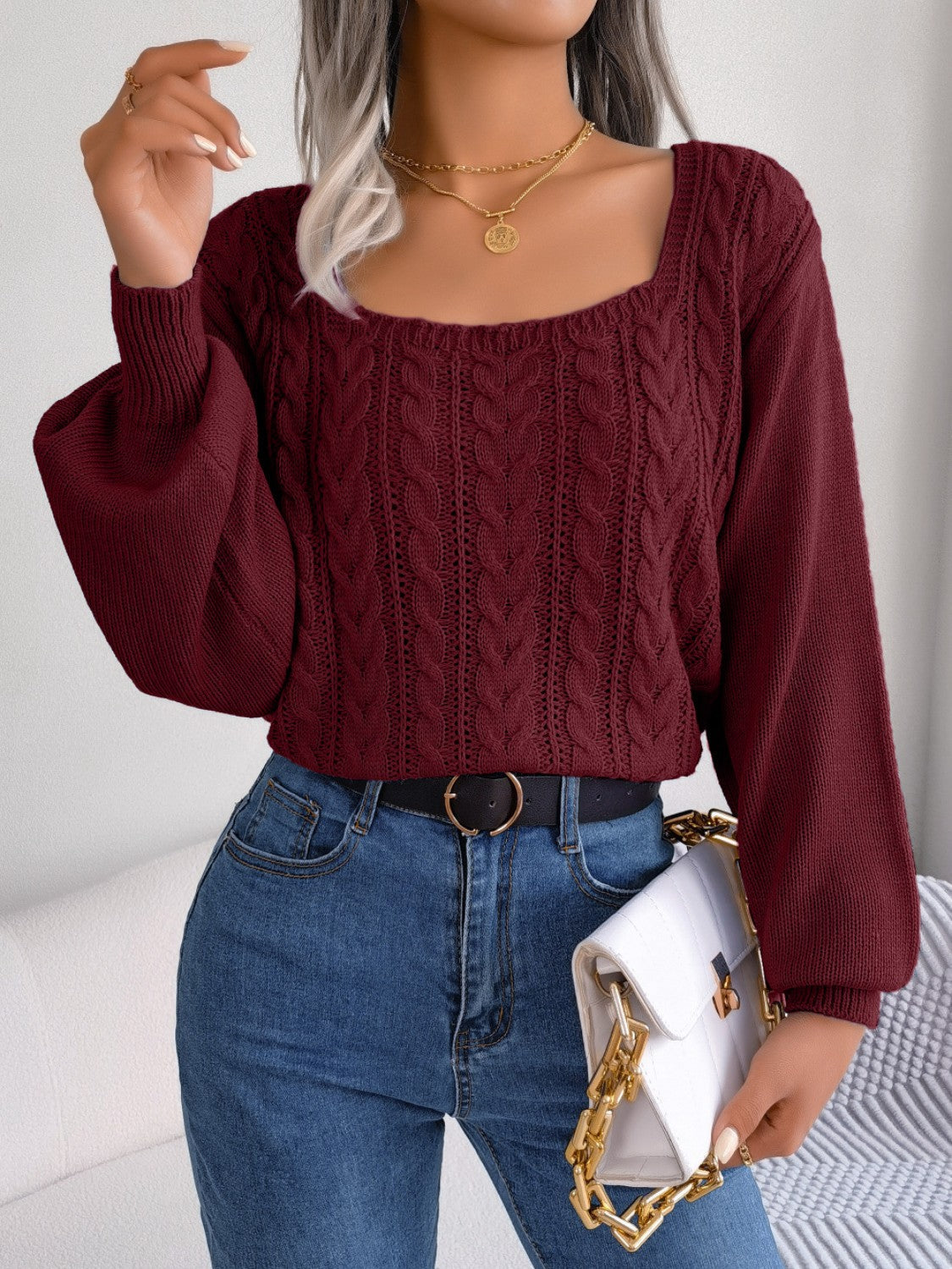 Wine cable knit sweater with square neckline and balloon sleeves.