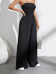 Black strapless tube top wide-leg romper with ruched waist detail.