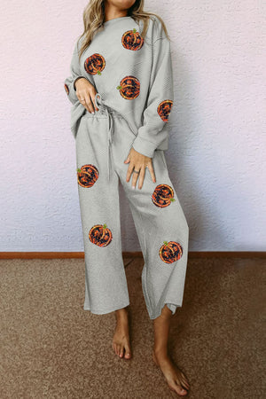 Textured grey loungewear set with pumpkin print, crew neck top and wide leg pants.