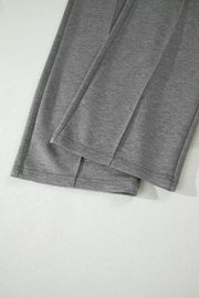 Dark gray wide-leg pants with stitched front detail and cuffed hems.