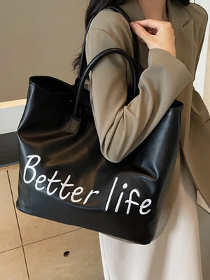 Black tote bag with white "Better life" graphic and top handles