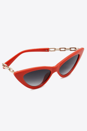 Chainlink cat-eye sunglasses in deep red with gold chain detail and gradient lenses.