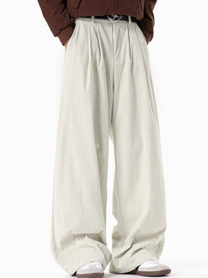 Men's cream pleated wide leg corduroy trousers with a relaxed fit.