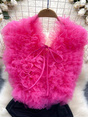Ruffled V-neck bodysuit in pink with lace detail and bow tie closure.
