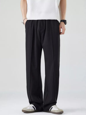 Black casual drawstring sweatpants with a relaxed fit and subtle pleating.