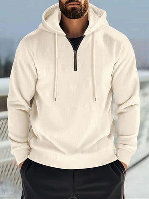 Beige waffle-knit quarter-zip hooded pullover with drawstring and black zipper.