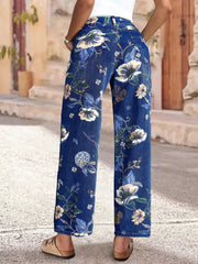 Light blue denim wide-leg jeans with a floral print and embellished details.