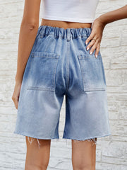 Light blue faded denim carpenter shorts with raw hem and elastic waistband.