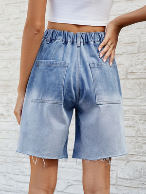 Light blue faded denim carpenter shorts with raw hem and elastic waistband.