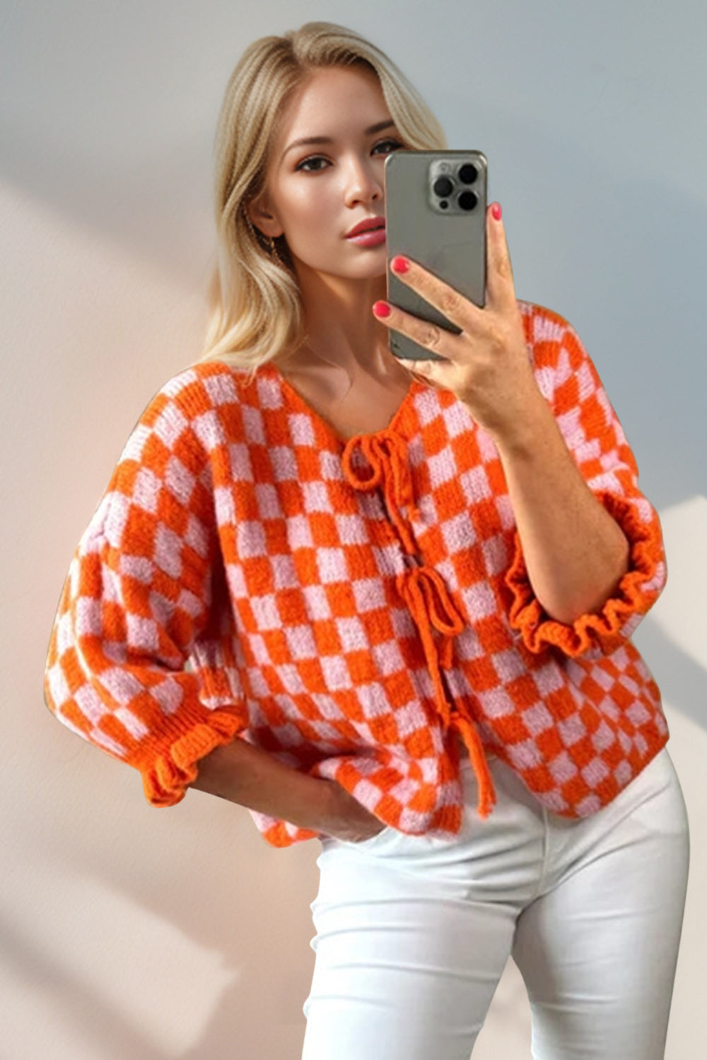 Orange and blush pink checkered knit cardigan with tie front and ruffle sleeves