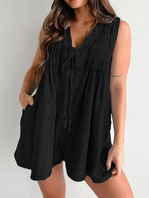 Black denim playsuit with V-neck tie front, sleeveless, A-line cut and pockets.