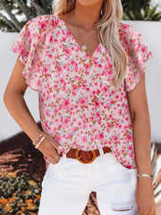 Floral v-neck blouse with flutter sleeves in pink and white floral print, polyester.