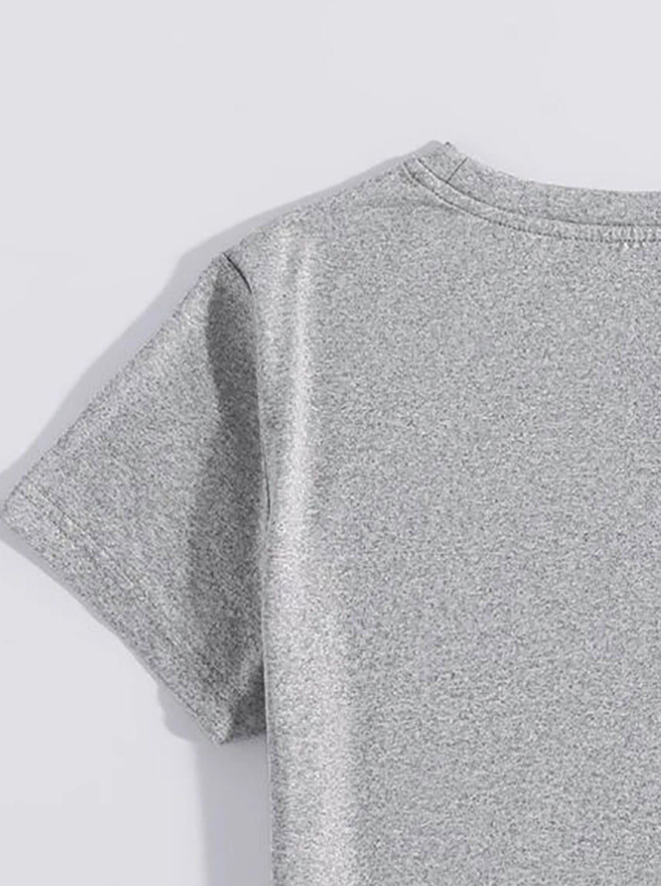 Gray polyester t-shirt with short sleeves and crew neck, showing fabric texture.