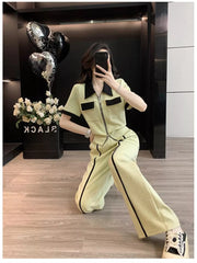 Chic beige zip-up top and wide-leg pants set with black trim and collar.