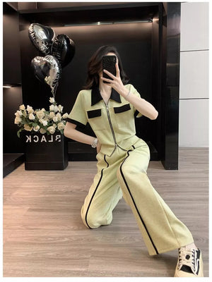 Chic beige zip-up top and wide-leg pants set with black trim and collar.
