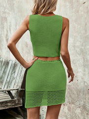 Green crochet vest and mini skirt set with openwork hem detail.