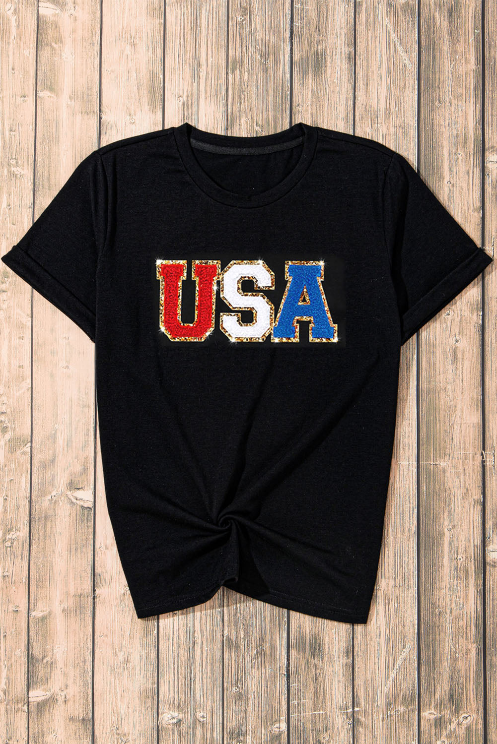 Black t-shirt with glitter USA appliqué in red, white, and blue.