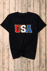 Black t-shirt with glitter USA appliqué in red, white, and blue.
