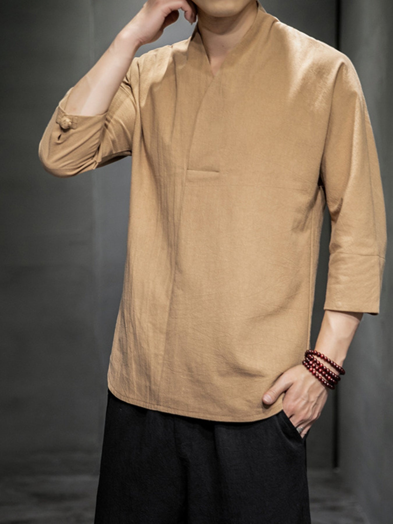 Men's tan 3/4 sleeve V-neck shirt with button detail on sleeve