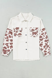 White cotton shacket with cow print sleeves and frayed edges.