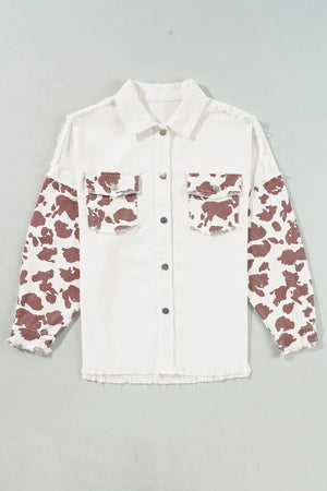 White cotton shacket with cow print sleeves and frayed edges.