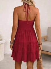 Red halter neck ruffled mini dress with tiered skirt and tie back.