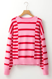 Colorblock stripe knit sweater with balloon sleeves in hot pink and red.