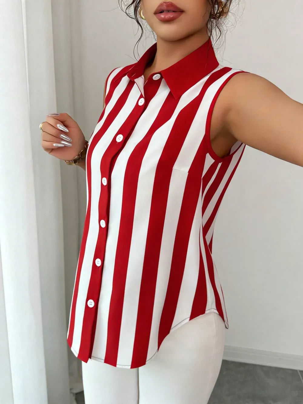 Red and white striped collared sleeveless shirt with button front.