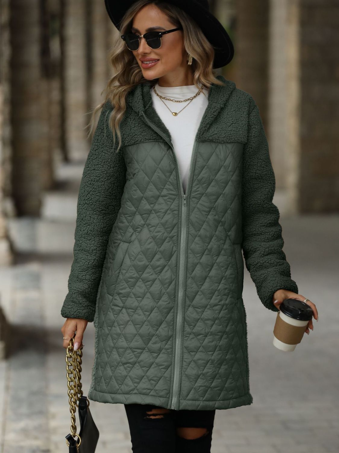 Army green teddy and quilted hybrid coat with a hood and zipper front.
