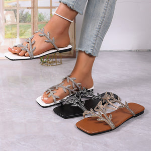 Rhinestone embellished leaf strap flat sandals in black, brown, and gray.