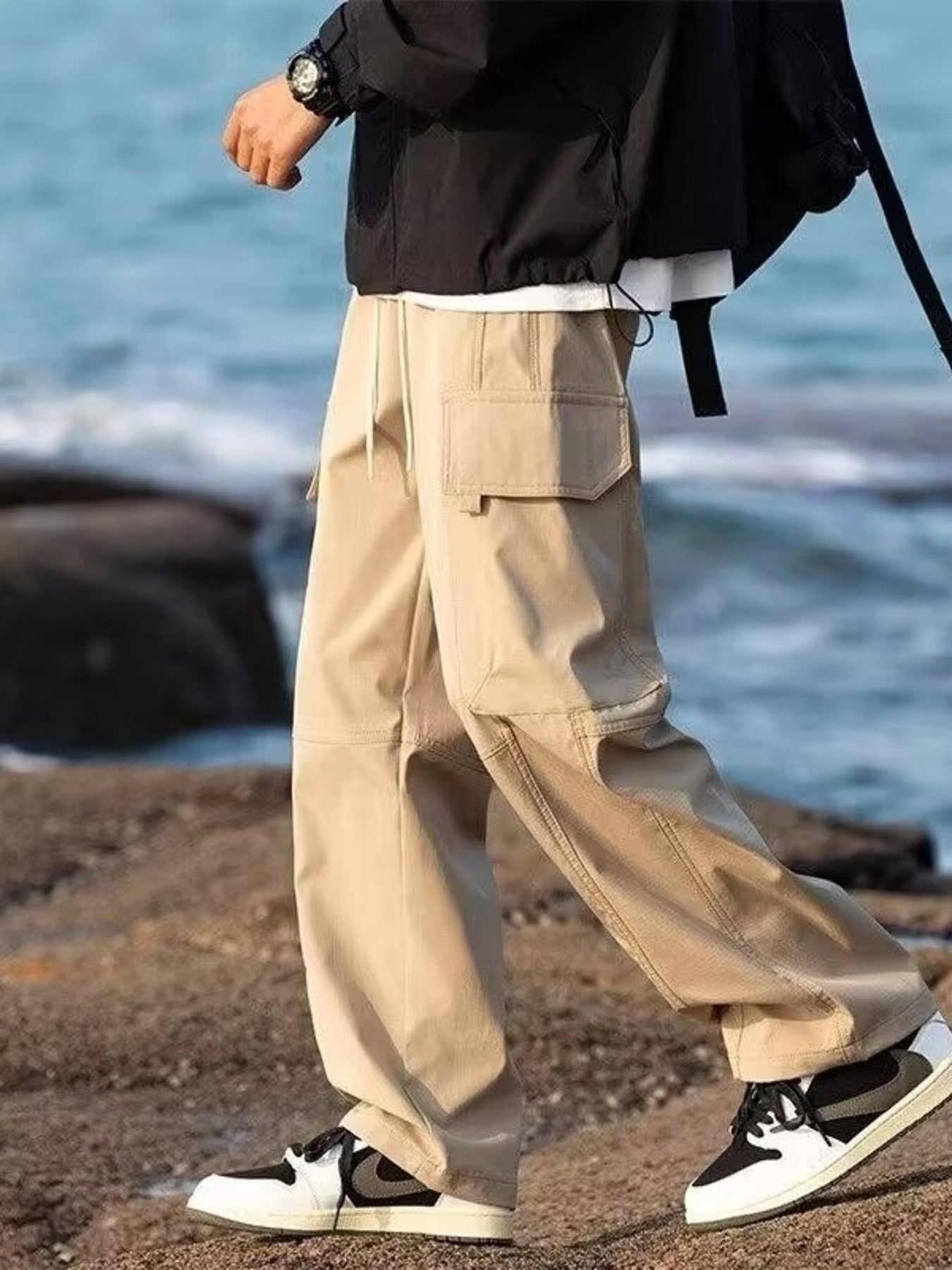 Khaki relaxed fit cargo pants with flap pockets and drawstring waist.